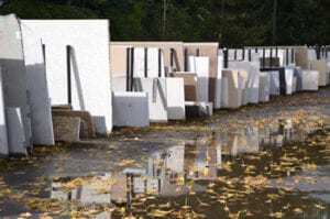 A row of white boxes sitting on top of the ground.